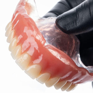 Upper Complete Denture Isolated On White Background. Selective F